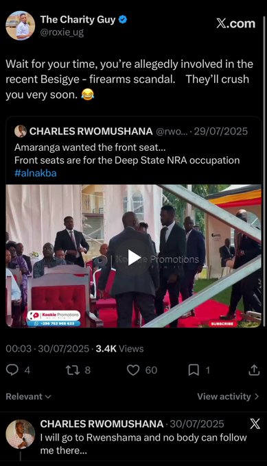 A screenshot of a post by 'The Charity Guy @roxie_ug' on X.com commenting on a tweet by 'CHARLES RWOMUSHANA @rwo...' with text mentioning 'Besigye - firearms scandal' and 'Amaranga wanted the front seat...' along with hashtags #nalnakba.