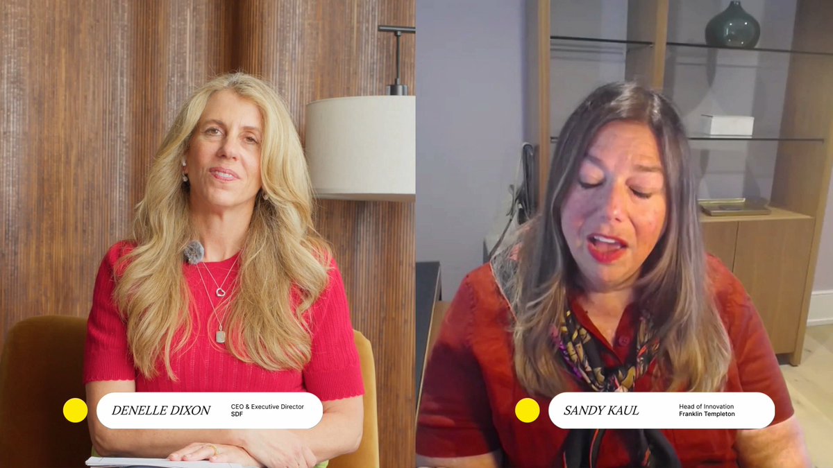 The image shows a split-screen video interview featuring Denelle Dixon, CEO & Executive Director of SDF, wearing a red top with long blonde hair against a wood-paneled background, alongside Sandy Kaul, Head of Innovation at Franklin Templeton, wearing a red patterned blouse with a scarf, seated in front of shelving. The caption connects to the post by depicting the two executives from SDF and Franklin Templeton discussing how onchain finance democratizes everyday financial services in celebration of Independence Day.
