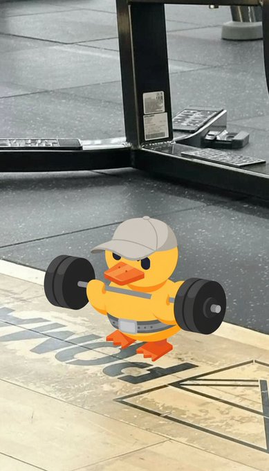 An illustration of a yellow cartoon duck wearing a white cap, lifting a heavy barbell in what appears to be a gym with mirrored walls and a tiled floor.
