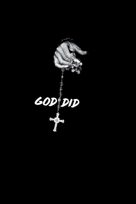 A black and white image of a hand holding a rosary with a cross, accompanied by the text 'GOD DID'.