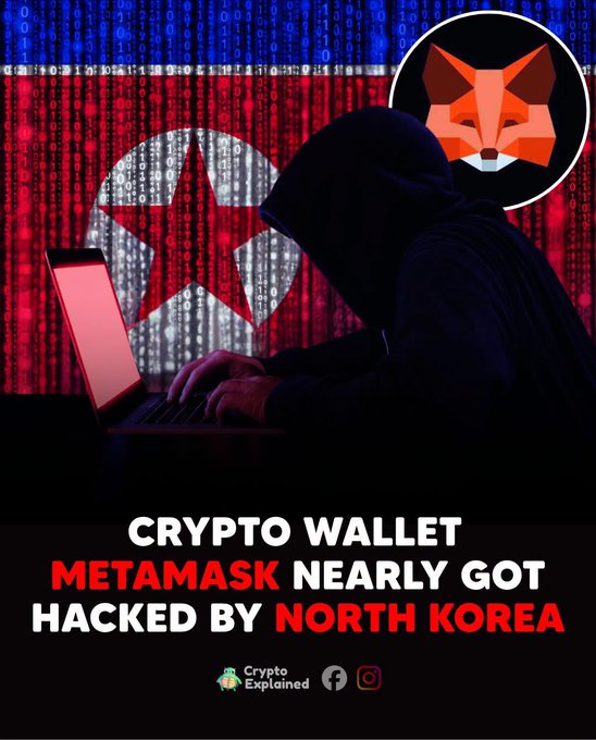 A hooded figure types on a laptop against a backdrop of the North Korean flag overlaid with binary code, with the MetaMask fox logo in the corner, illustrating how a North Korean hacker ("Tyler") allegedly infiltrated the MetaMask development team for about a month under a fake identity. The bold headline reads "CRYPTO WALLET METAMASK NEARLY GOT HACKED BY NORTH KOREA."