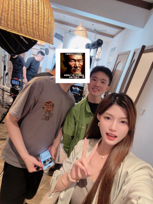 The image shows a young man and woman taking a selfie in what appears to be a photography studio, with the woman flashing a peace sign while holding a phone. There's an inset image of "Boss Shi" (老板说) with Chinese text referencing his journey from 10,000 to 100 million, connecting to the post about joining him for a live stream on OKX Planet to discuss his success story.