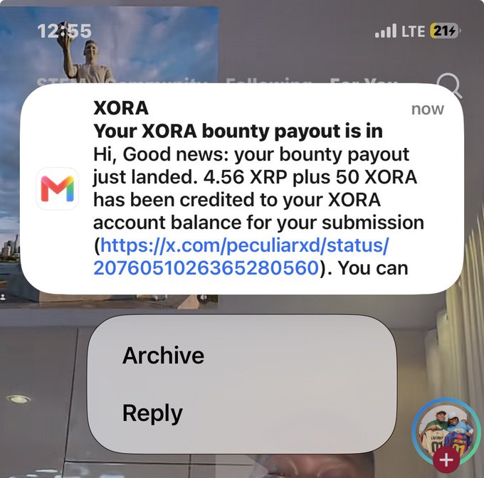 A smartphone notification from XORA announcing a bounty payout of 4.56 XRP plus 50 XORA, with options to Archive or Reply.