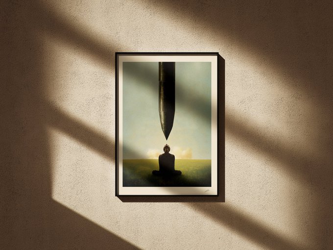 A framed surrealist print hangs on a beige wall with diagonal shadows, depicting a meditating figure beneath a giant pen tip against a green and yellow background.