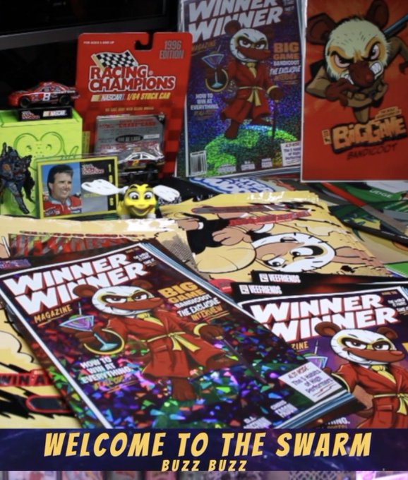 A colorful display of merchandise featuring 'WINNER WINNER' magazines with a bird mascot character, 'RACING CHAMPIONS' NASCAR items, and 'BADMAN' products, with the text 'WELCOME TO THE SWARM BUZZ BUZZ' overlaid at the bottom.