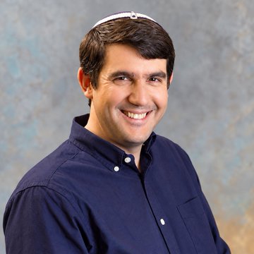 A man is shown in the image wearing a blue button-up shirt and a kippah, smiling at the camera.

The image likely depicts Yehuda Lindell, Coinbase's top cryptographer referenced in the post, who is pushing back against Justin Drake's warnings about AI potentially cracking the cryptography securing BTC and ETH before quantum threats emerge.