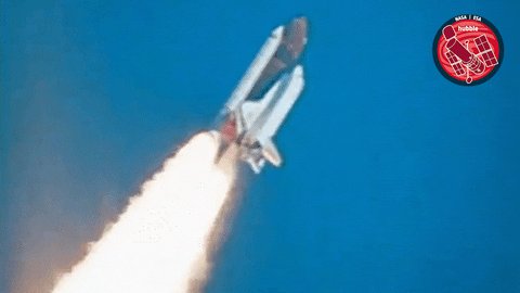 The image shows a space shuttle launching into space, with smoke coming out of the back of the shuttle as it ascends. The caption reads "Some coins chase the moon. CT may want to fasten its seatbelt." This phrase could be interpreted as a metaphor for the idea that we are all chasing our own goals and dreams in life, just like the space shuttle is chasing the moon.