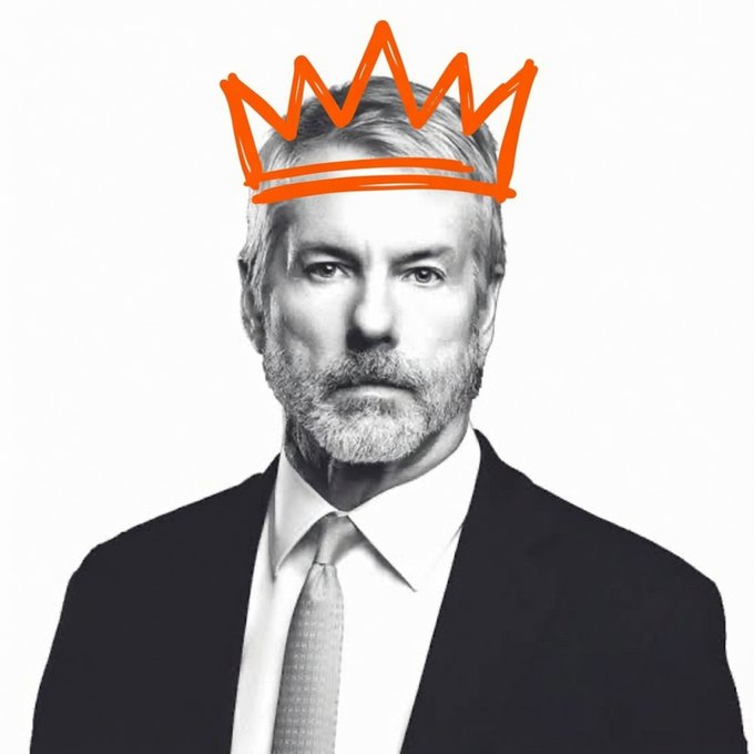 A black-and-white portrait of a man in a suit with an orange hand-drawn crown doodled on his head.