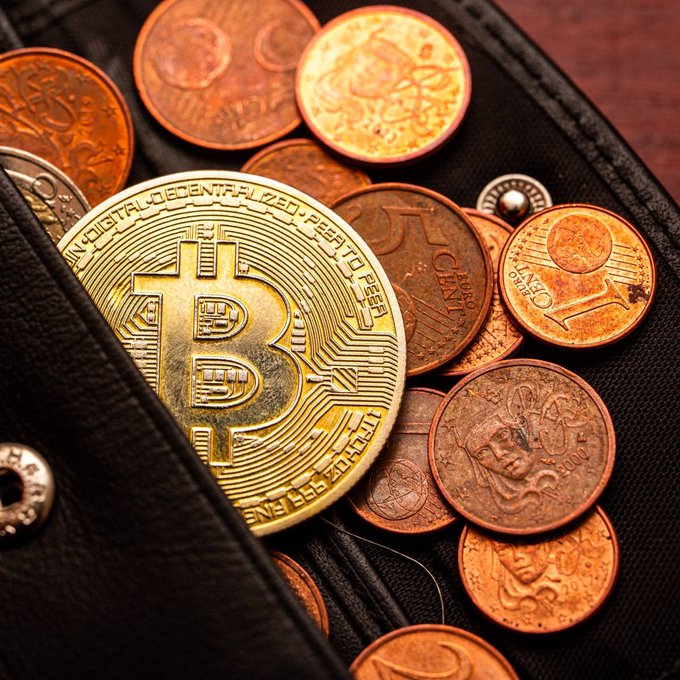 A gold Bitcoin coin rests among copper pennies and a Euro cent inside a black wallet, symbolizing the crypto and fiat currencies at stake in Ledger's reported $86 million security exploit.