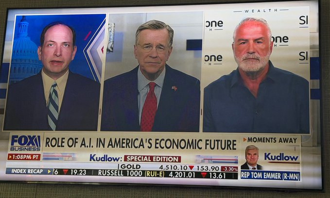 A Fox Business news broadcast titled 'ROLE OF A.I. IN AMERICA'S ECONOMIC FUTURE' showing a three-way interview panel, with stock ticker showing gold at 4,510.10 and the Russell 1000 index.