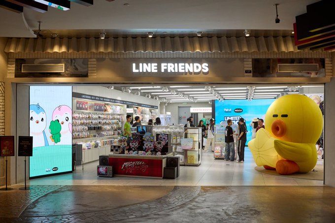 The image shows the storefront of a "LINE FRIENDS" retail shop, likely located in a Shanghai mall, featuring merchandise displays and a large yellow duck mascot figure on the right side. This aligns with the caption about Pengu being spotted in Shanghai, as Line Friends is a popular character brand featuring the penguin character Pengu (also known as Sally's friend) among its lineup of cute mascot characters.