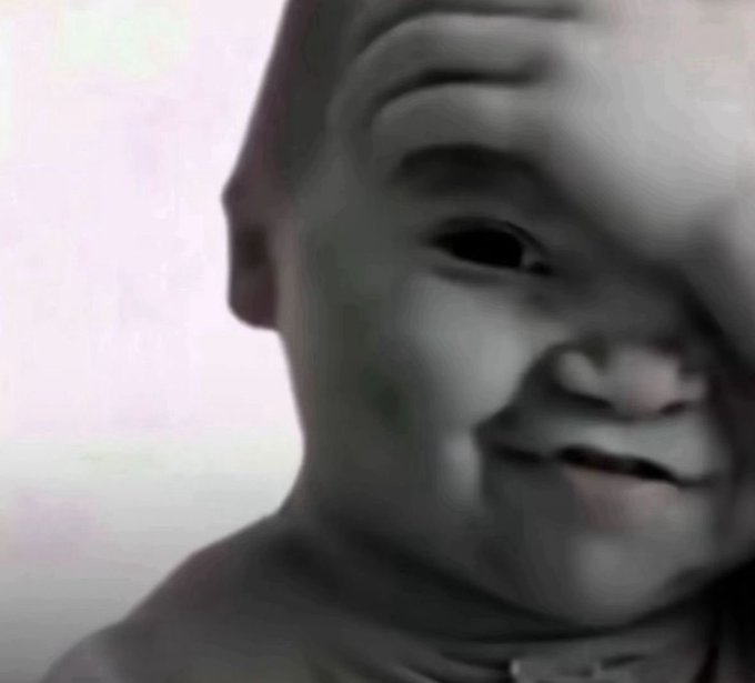 The image features a baby with their face partially obscured by their hand, giving an impression of curiosity or playfulness. The background appears to be a light pink color, which contrasts nicely with the black and white tones of the photo. The caption "Can't wait to buy $SOL at 8$ again" is written in the image, suggesting that there might be a sale for a specific item related to the baby's needs or development.