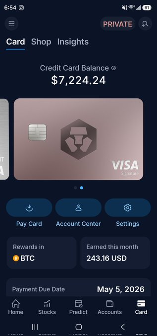 The image shows a phone screen displaying information about a credit card. The credit card has a foreign design and is associated with cryptocurrency mining, as evidenced by the Bitcoin symbol in its center. On the screen, there is a chart showing the amount of Bitcoin earned back so far for the user's @cryptocom credit card through transactions. Specifically, the user has earned $73,214.24 worth of Bitcoin. The post below the display suggests that the account holder could potentially earn more from their account by taking advantage of an ongoing promotion to purchase Bitcoin directly from the issuer. The screen also includes a list of options for purchasing Bitcoins and offers suggestions on how to maximize profits through mining operations or other means.