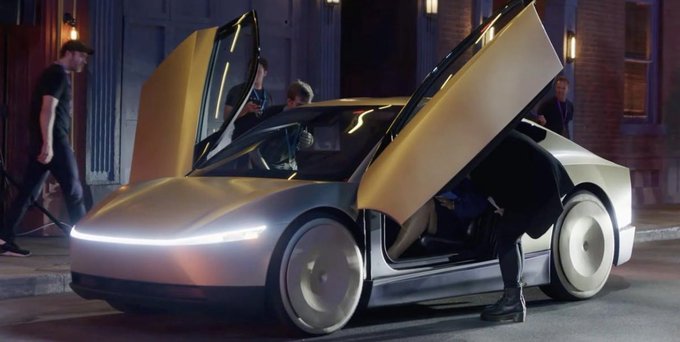 A silver Tesla Cybercab with its butterfly doors open is parked on a city street at night, as people inspect and enter the futuristic vehicle. The image illustrates the post's point about Tesla's $1.4T market value being increasingly tied to its pivot beyond traditional car manufacturing toward AI and autonomous "robotaxi" technology—shown here with the steering-wheel-free, pedal-less design that Wall Street is pricing in.
