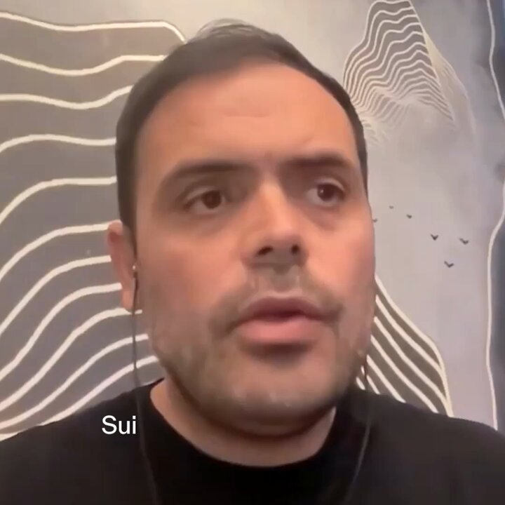 The image features a man with a beard wearing a black shirt, looking at the camera while talking. The caption of the image includes the names @kostascrypto and @SuiNetwork, which are likely related to the content being discussed in the conversation or the context of the image.