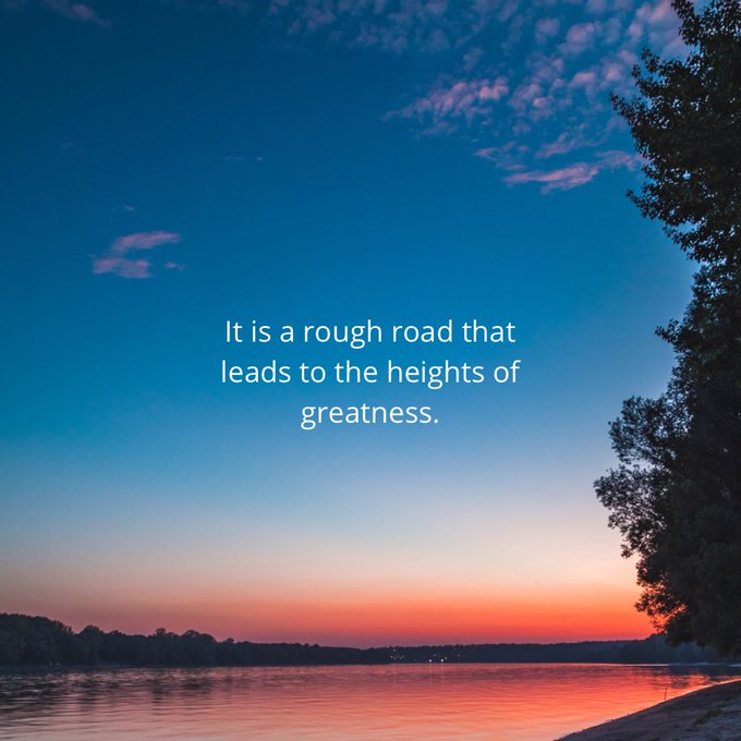 A scenic sunset over water with the inspirational quote: 'It is a rough road that leads to the heights of greatness.'
