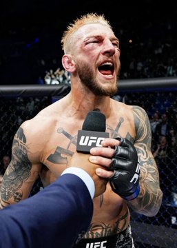 A shirtless, tattooed UFC fighter with blond hair is shown screaming in celebration or emotion while holding up a UFC-branded microphone, likely after a victory. The image visually represents Dan Hooker, the MMA fighter referenced in the post discussing his low 19% odds against Salahdine Parnasse.