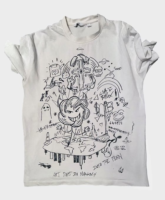 White t-shirt featuring black line-art doodle artwork of a cartoon character with various illustrations and text including 'ART DIES IN MARGINS' and 'INTO THE FEAR'.