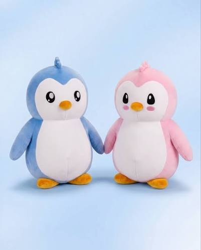 Two adorable plush penguins—one blue and one pink—are displayed side by side, representing Pudgy Penguins toys that have been sold in stores, illustrating the post's point about the brand's expansion beyond NFTs into real-world merchandise.