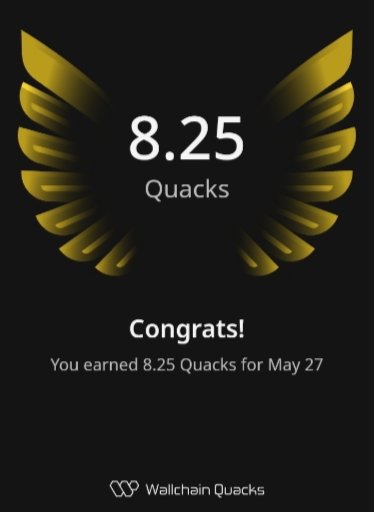 The image features an advertisement for Quicksilver, which is promoting its new cryptocurrency called Quark. The advertisement includes a gold-colored logo with wings and the text "Congratulations! You earned 8.25 Quacks for May 27". This suggests that users have successfully completed a Quark mining challenge or achieved some other milestone related to Quark.
