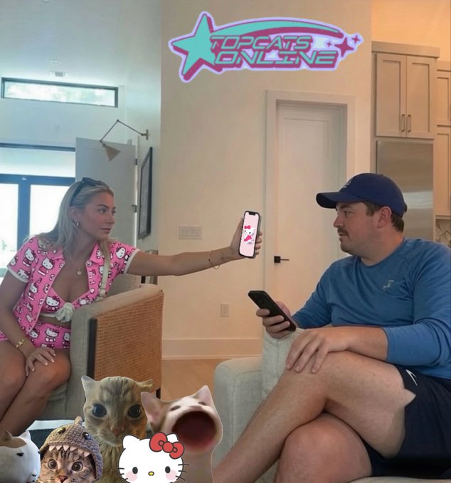 Two people sitting on couches in a living room, with the woman showing something on her phone to the man; the image features a 'TUPCATS ONLINE' logo at the top and Hello Kitty stickers at the bottom.