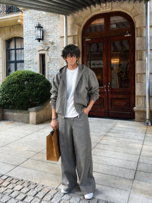 A young man in a relaxed gray tracksuit and white tee stands outside an elegant stone building with arched wooden doors, holding a brown paper bag—fitting the "gm" (good morning) vibe of a calm, productive Wednesday start.