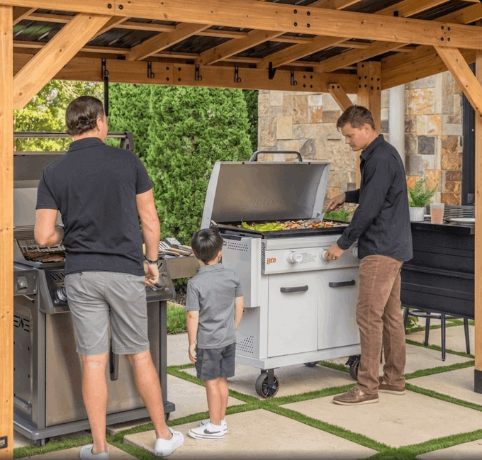 A casual backyard BBQ scene shows two men grilling and a young boy standing between them under a wooden pergola, with a stainless steel grill bearing the "RCS" logo visible in the center. The image's leisurely outdoor gathering contrasts with the post's humor about a man paralyzed by analysis who watched Bitcoin soar from $3,200 to $64,000 over six years without ever buying—missing out on significant gains while life (and good food) passes him by.