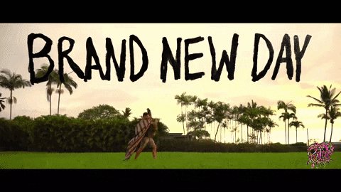 The image features a banner with the text "Brand New Day" written in black marker. The background of the image shows palm trees against a sky backdrop, suggesting that the scene takes place outdoors during the morning hours.