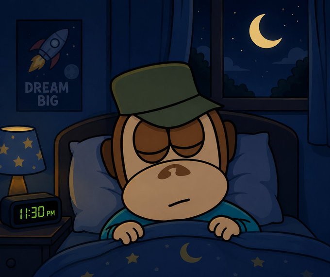 A cartoon illustration of a sleepy monkey wearing a green cap lying in bed at night, with a digital clock showing 11:30 PM and a "DREAM BIG" rocket poster on the wall.