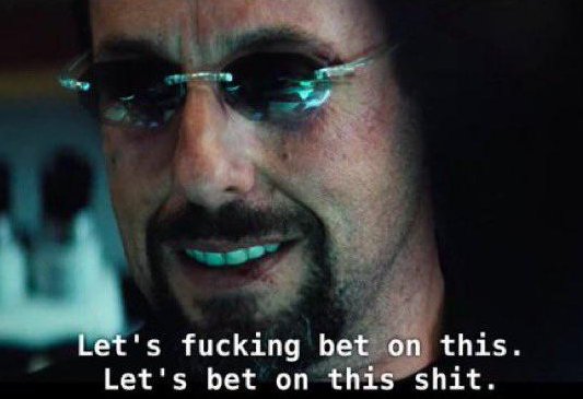 The image features a close-up of a man wearing sunglasses, with his face partially visible behind them. Below him, there are two lines of text that read "Let's be bet on this. Let's be on this shit." The man is smiling at the camera and appears to be in a relaxed or playful mood.