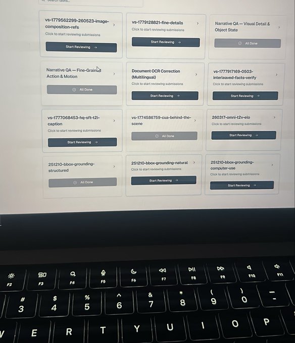 The image shows a laptop screen displaying a grid of data annotation/review tasks on the Outlier platform, including projects like "Narrative QA – Visual Detail & Object State," "Document OCR Correction (Multilingual)," and various bounding-box annotation tasks (251210-bbox-grounding), with several marked "All Done." The visible keyboard in the foreground suggests the user is actively working through these review queues, directly supporting the post's call for people with Outlier reviewer experience.