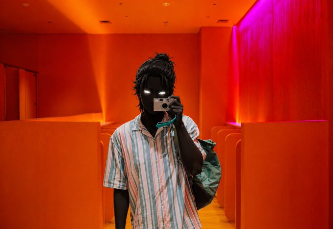 A person with glowing white eyes takes a mirror selfie in a vibrantly lit orange and magenta room, holding a camera. The image aligns with the motivational post, visually representing the "GM" (good morning) vibe and the energetic, goal-setting tone aimed at engaging their crypto community and the @BeldexCoin audience.