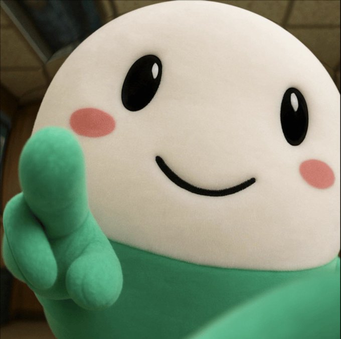 A plush mascot character with a big smile, rosy cheeks, and a green body gives a thumbs-up to the camera. The cheerful figure visually reinforces the post's welcoming message from $cupsey, embodying the friendly, inclusive tone of the announcement.