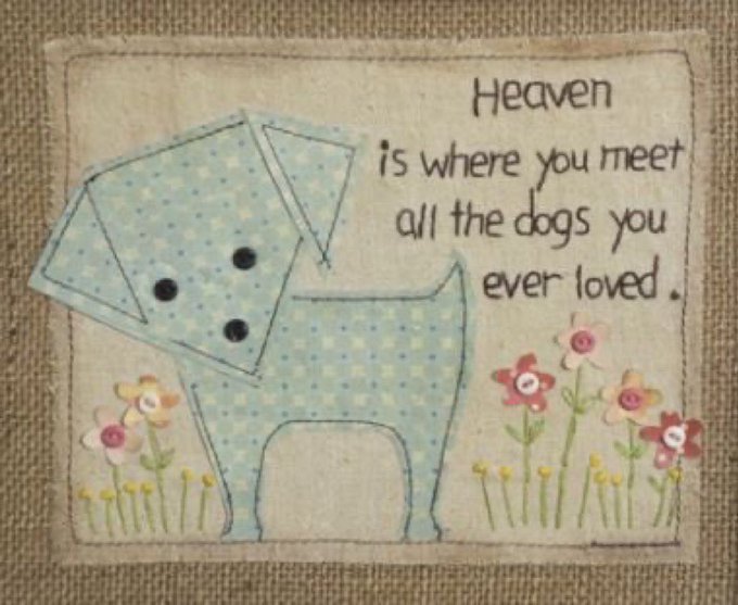 A fabric quilted patch featuring a stitched light blue dog with the embroidered text 'Heaven is where you meet all the dogs you ever loved,' surrounded by small flower designs.