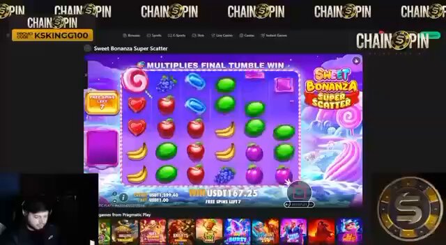 The image shows a video game interface with various elements such as a slot machine, fruits, and a man playing the game. The main focus of the image is a slot machine that has a colorful display featuring different fruits like apples, bananas, and oranges. The slot machine also displays a message about a Sweet Bonanza Casino game, which suggests it could be a part of a casino gaming system or a digital entertainment platform offering various gaming experiences.