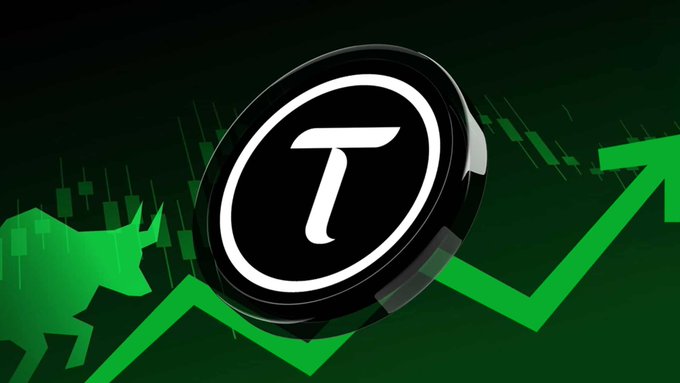 The image features a coin that has the letter "T" on it, surrounded by green stock prices rising against a black background. It suggests an investment opportunity with cryptocurrency or market trends shown within the image. The post's context states that @opentensor is now Trending on @coingecko, indicating potential interest in this particular trend or topic related to the coin depicted in the image.