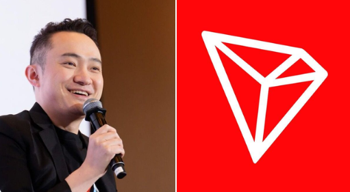 A man in a dark suit smiles while holding a microphone next to a red background displaying the white geometric TRON (TRX) logo.