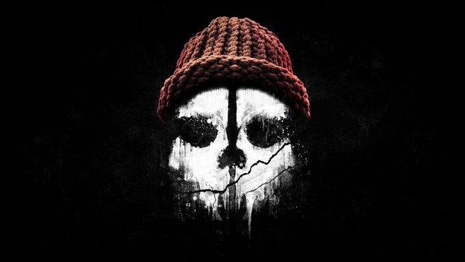 A dark, stylized image featuring a cracked skull wearing a red knitted beanie against a black background.