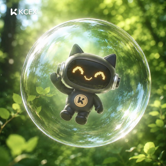 A promotional image for KCEX featuring a cute black robot mascot with a smiling pixelated face inside a transparent bubble, set against a green forest background.