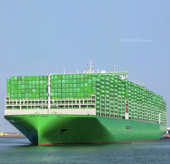 A massive green container ship sails on calm waters under a clear blue sky, with "@TheBTTherapist" watermarked in the corner. The image's striking green color cleverly mirrors the post's reference to "everywhere is green," symbolizing the theme of crypto projects like @BeldexCoin and @sleepagotchi building sustainable, privacy-focused ecosystems.