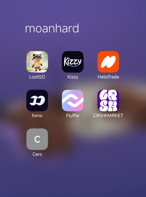 A smartphone home screen labeled "moanhard" displays a folder of Monad ecosystem apps (LootGO, Kizzy, HelloTrade, fomo, Fluffle, CRSHMARKET, and Cero), perfectly illustrating the post's joke by showcasing a collection of Monad-based dApps as subtle proof of being a "Monad maxi."