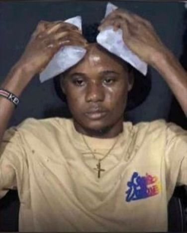 A young person wearing a yellow t-shirt featuring a colorful graphic design presses white tissues or cloths against their head, with their shirt also displaying "CK" on the sleeve. The accompanying Pidgin English caption expresses frustration about having spent all their money trying to find money without success, with the image visually conveying that same emotional exhaustion and despair.
