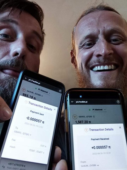 Two bearded men hold up smartphones displaying transaction details in Pi cryptocurrency, showing a payment sent of '-0.000057 π' and received of '+0.000057 π'.