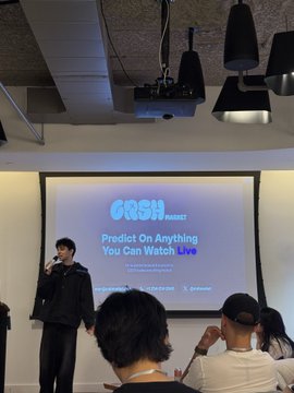 A presenter stands on stage introducing "GRSH MARKET," a platform described as a "Twitch + Kalshi" prediction market layer for live content. The projection screen clearly displays the GRSH MARKET logo and the tagline, "Predict On Anything You Can Watch Live."