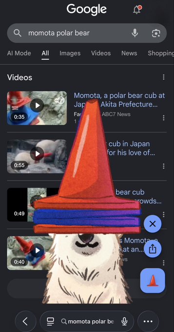 A screenshot of a Google search for "momota polar bear" shows video results about a polar bear cub named Momota at a zoo in Japan, overlaid with a large illustration of an orange traffic cone and a cartoon polar bear wearing a colorful cone hat. The image visually promotes the joke from the post, tying the orange Google Trends cone—a meme about surging search interest—to the viral $Momota token as a "runner" on Google.