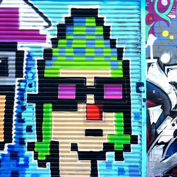 A colorful pixel art mural depicting a character with a green and blue checkered hat, purple sunglasses, and a green jacket, painted on a metal roll-up door.