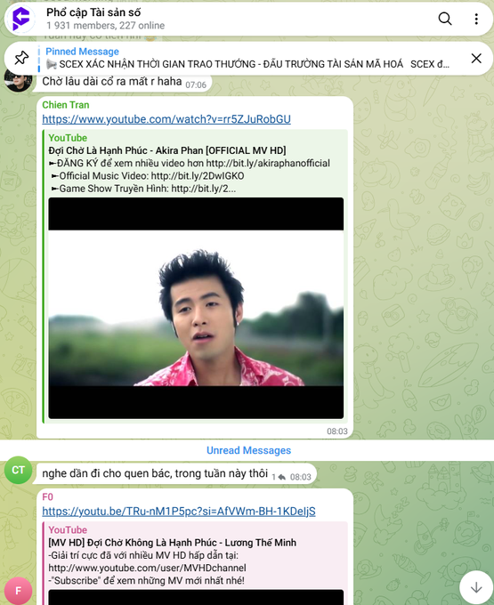 A Telegram chat interface in Vietnamese showing a group called 'Phổ cập Tài sản số' with pinned messages linking to YouTube videos for songs like 'Đợi Chờ Là Hạnh Phúc' by Akira Phan.