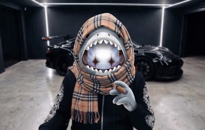 A figure in a Burberry-patterned scarf wears a shark mask and holds a cigar in a showroom with luxury cars behind them, the absurd juxtaposition of high-end fashion and the chaotic shark-mask persona mirroring the post's ironic tone about aging poorly and misplaced confidence.