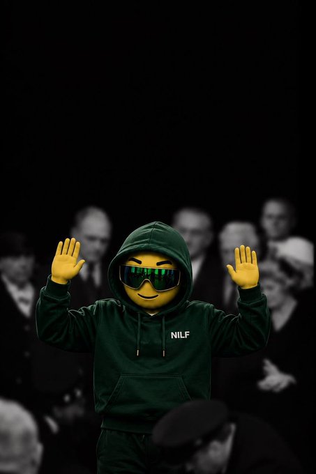 A 3D-rendered yellow emoji character wearing a green hoodie labeled 'NILF' and sunglasses, with both hands raised, set against a dark background with blurred figures.
