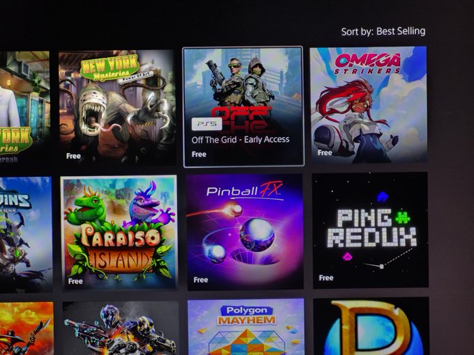 A PlayStation Store interface showing various free game tiles sorted by Best Selling, including titles like 'New York Mysteries,' 'Off The Grid - Early Access,' 'Omega Strikers,' 'Paraíso Island,' and 'Pinball FX.'